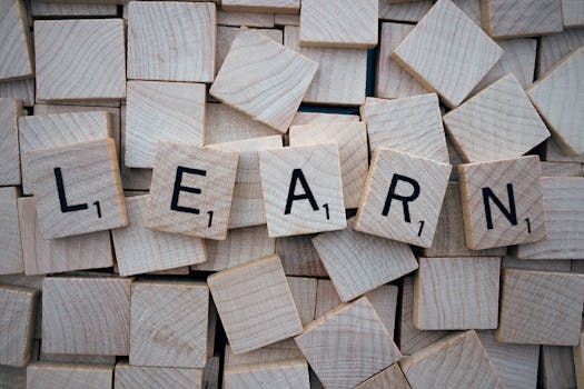 pexels-photo-247819-247819 Wooden letter tiles arranged to spell 'learn' on a background of scattered tiles.